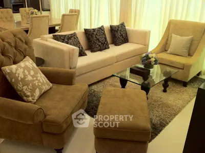 Elegant living room with plush seating and glass coffee table, perfect for relaxation and entertaining.