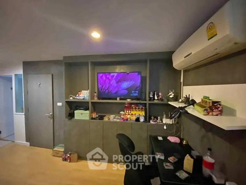 Modern study room with built-in shelves and air conditioning, perfect for productivity.