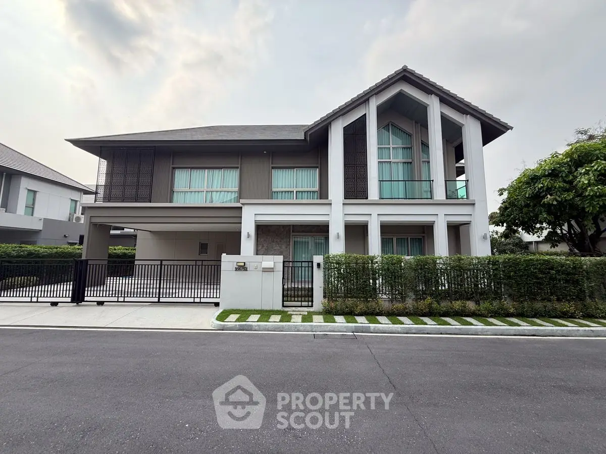 Stunning modern two-story house with large windows and elegant facade in a serene neighborhood.