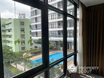 Modern apartment view overlooking pool and cityscape