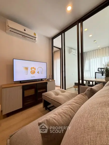 Modern living room with stylish furniture and air conditioning, featuring a cozy ambiance and natural light.