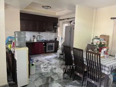 Spacious kitchen with dining area, featuring modern appliances and elegant marble flooring.