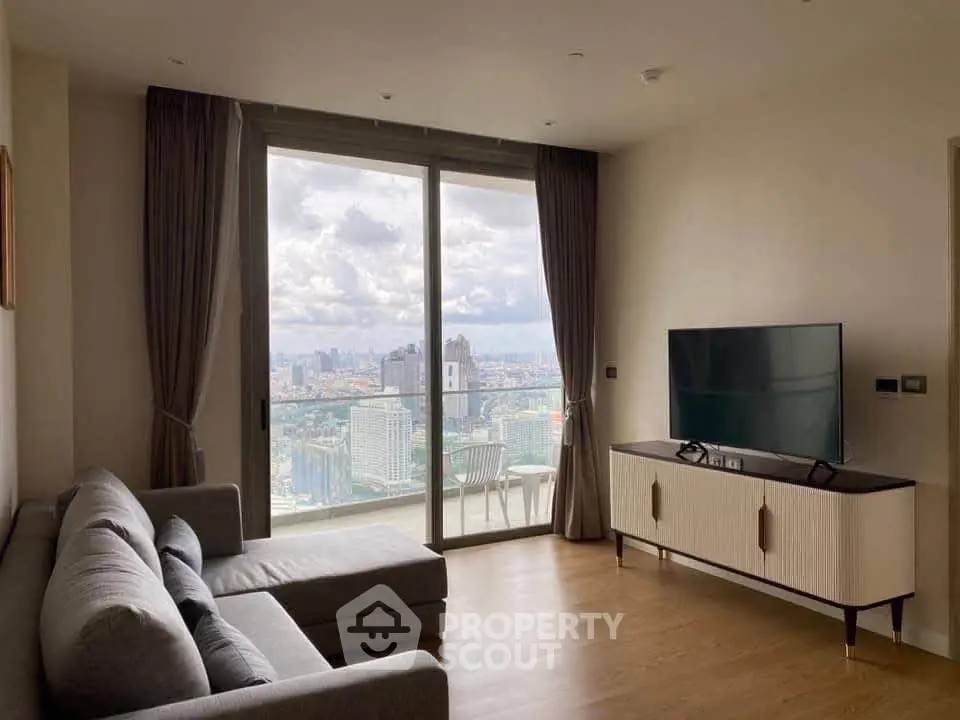 Modern living room with city view, featuring sleek furniture and large windows for natural light.