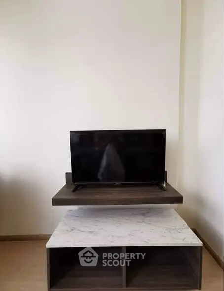 Modern living room with sleek TV stand and marble accent table
