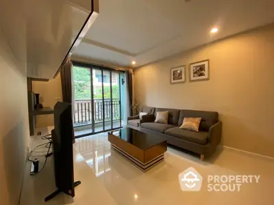 Spacious living room with glossy tiled flooring, modern grey sofa, and large windows leading to a sunny balcony, perfect for relaxing and entertaining.