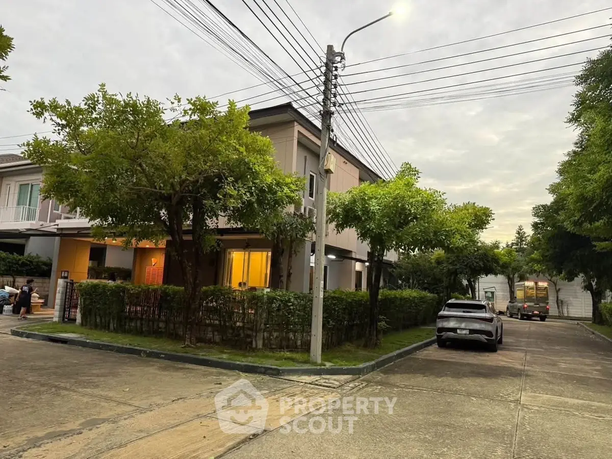 Charming suburban home with lush greenery and street view, perfect for family living.