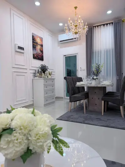 Elegant dining room with chandelier and modern decor, perfect for stylish entertaining.