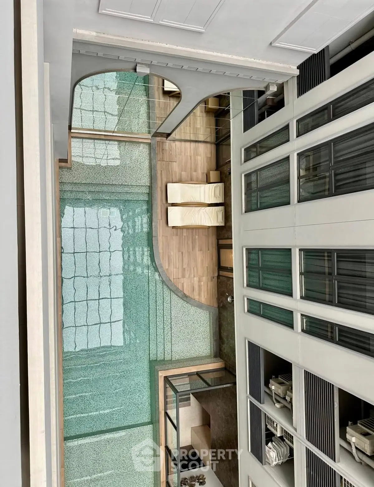 Luxurious indoor pool area with modern design and glass features in a high-end residential building.