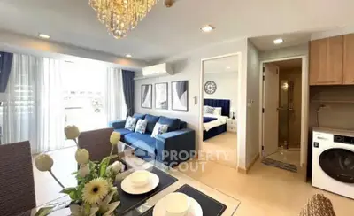 Modern open-plan living room with elegant decor and natural light