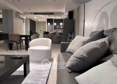 Modern living room with stylish furniture and open kitchen layout