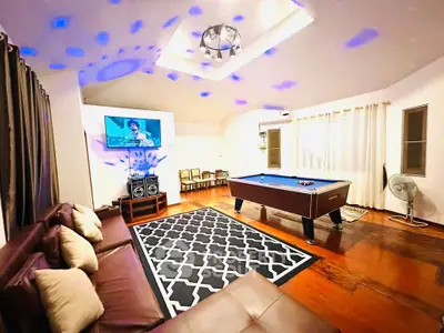 Spacious living room with pool table and modern entertainment setup