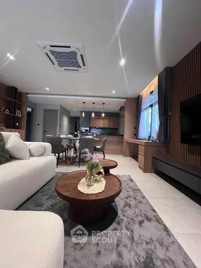 Luxurious modern living room with elegant decor and open kitchen layout, perfect for stylish urban living.