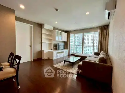 Spacious modern living room with large windows and elegant furnishings