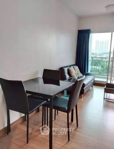 Modern living room with sleek furniture and city view balcony.