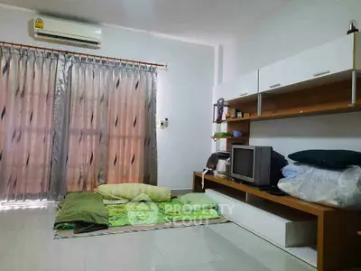 Cozy living room with air conditioning and modern shelving unit, perfect for relaxation.