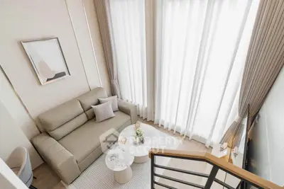 Modern living room with stylish decor and large windows in a contemporary apartment.