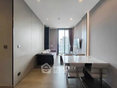 Modern living room with city view, sleek furniture, and dining area in a stylish apartment.
