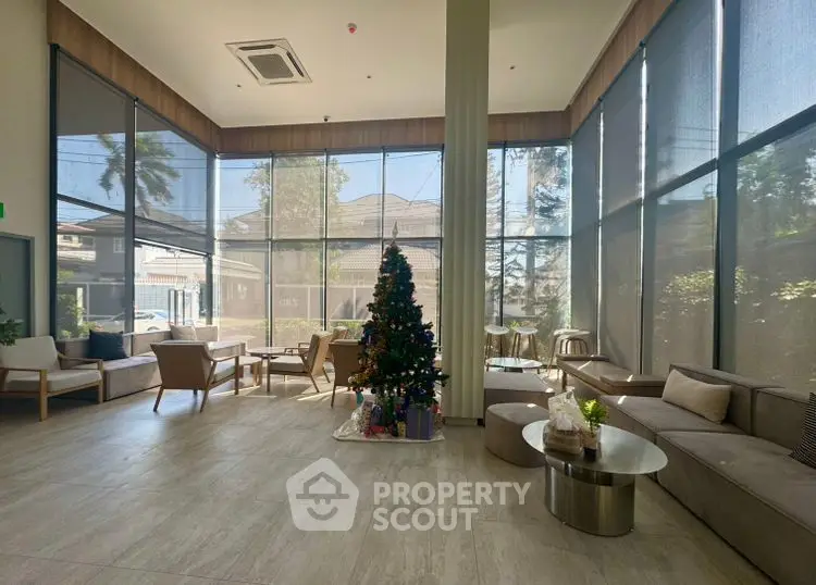 Spacious modern living room with large windows and Christmas tree, perfect for gatherings.