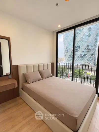 Modern bedroom with large windows offering stunning city view and elegant furnishings.
