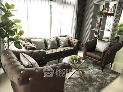 Luxurious living room with elegant brown sofas and glass coffee table, perfect for relaxation and entertaining.