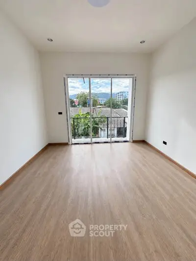 Spacious empty room with large windows offering a scenic view, perfect for customization.