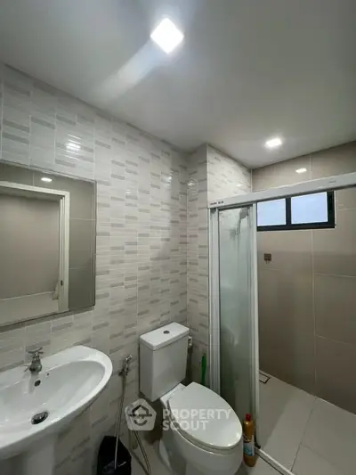 Modern bathroom with shower and sleek tile design
