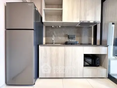 Modern kitchen with sleek appliances and minimalist design, featuring a spacious fridge and stylish cabinetry.