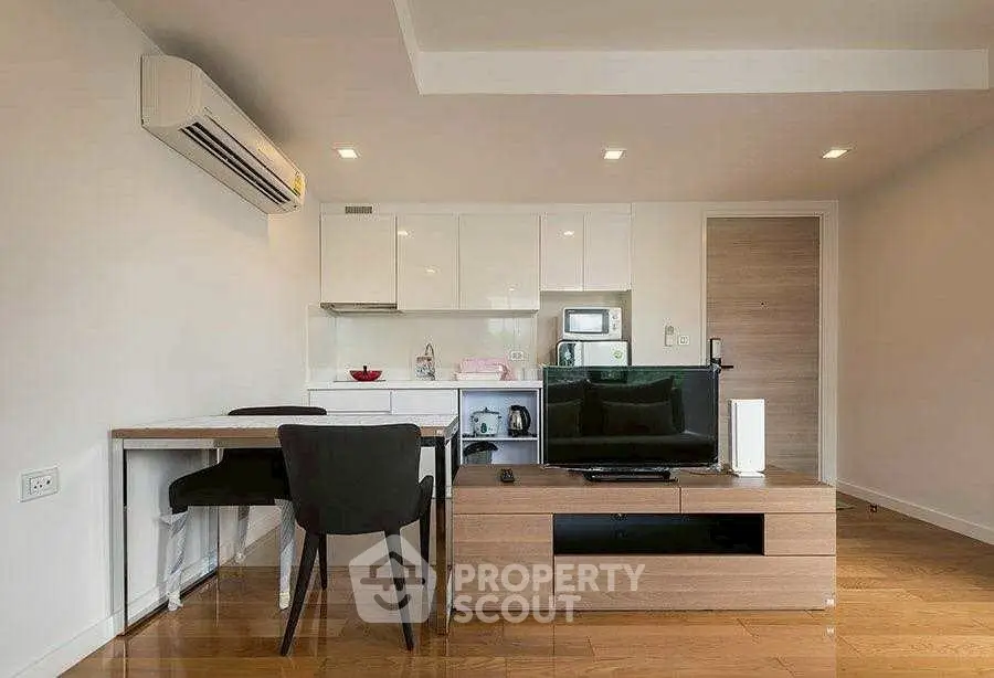 Modern living room with sleek furniture and integrated kitchen appliances