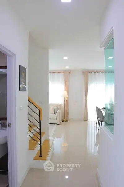 Bright modern interior with open living and dining area, featuring sleek design and natural light.