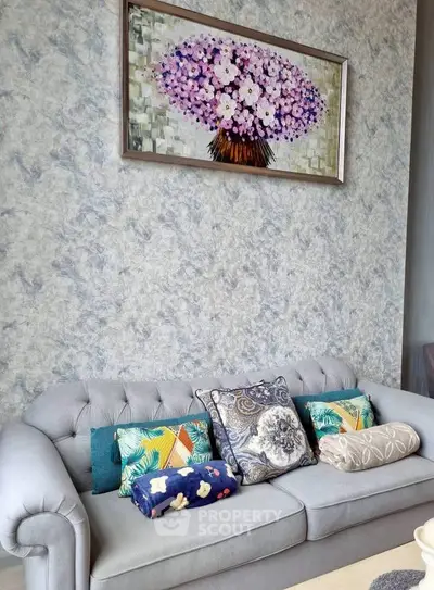 Elegant living room with stylish sofa and floral artwork, perfect for modern home decor.