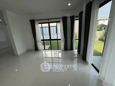 Spacious modern living room with large windows and garden view