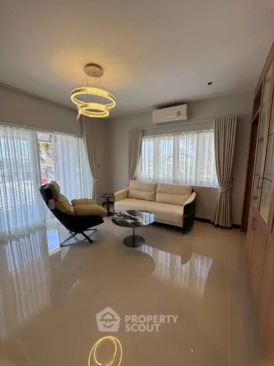 Spacious living room with modern furniture and large windows for natural light.
