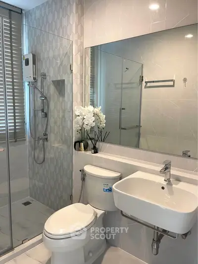 Modern bathroom with glass shower and sleek fixtures