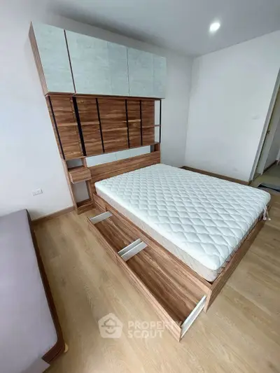 Modern bedroom with stylish wooden bed and ample storage space