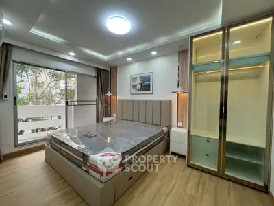 Modern bedroom with large window and stylish wardrobe in a cozy apartment.