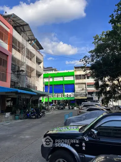 Vibrant urban building exterior with colorful facade and clear blue sky, showcasing city living.