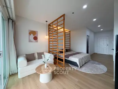 Modern studio apartment with stylish partition, cozy living area, and elegant decor.