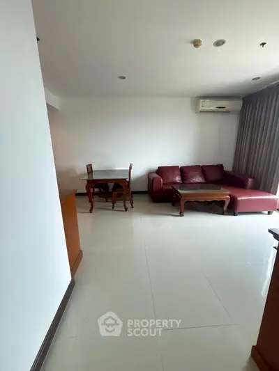 Spacious living room with modern furniture and air conditioning in a stylish apartment.