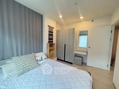 Modern bedroom with stylish decor and ample storage in a cozy apartment.