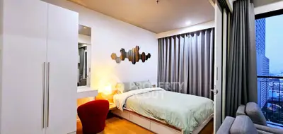 Modern bedroom with stylish decor and city view from window