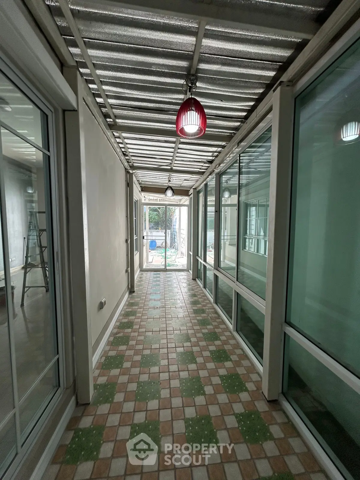 Spacious corridor with glass windows and tiled floor in modern building