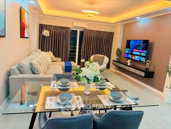 Luxurious modern living room with elegant dining area and wall-mounted TV, perfect for entertaining.