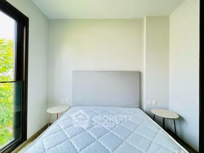 Bright bedroom with large window and minimalist decor