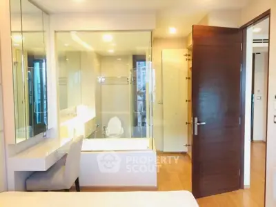 Modern bathroom with glass partition and wooden accents in luxury apartment