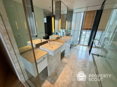 Luxurious modern bathroom with dual sinks and floor-to-ceiling windows