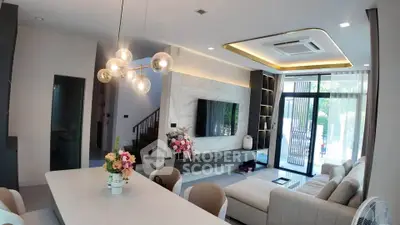 Luxurious modern living room with elegant decor and large windows for natural light.