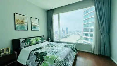Stunning bedroom with panoramic city view and modern decor in high-rise apartment.