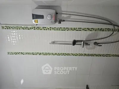 Modern bathroom with water heater and stylish tile design.
