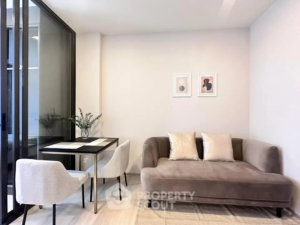 Modern living room with cozy sofa and dining area in stylish apartment.
