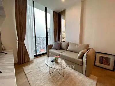 Modern living room with elegant sofa and floor-to-ceiling windows offering city views.